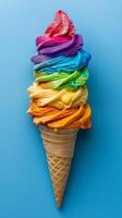 Rainbow color ice cream in a cone on a blue background, pride celebration with copy space banner, photo