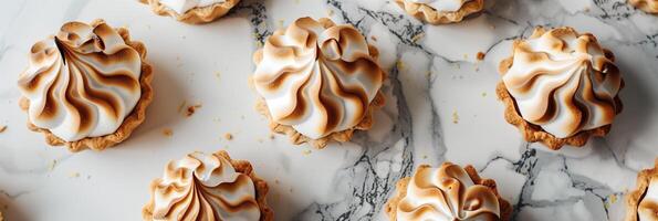 Artisanal lemon meringue pies with golden-brown peaks, freshly baked and cooling on a marble countertop, photo
