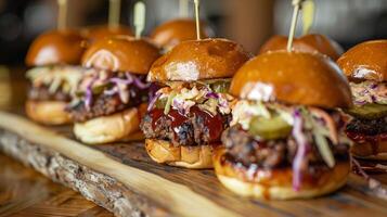 BBQ pork sliders topped with coleslaw and pickles lined up neatly on a rustic serving board, photo