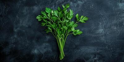Fresh parsley leaves, with stems, displayed neatly on a plain, flat black surface, photo