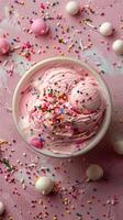 Top-down view of empty pastel pink table with scattered ice cream sprinkles, photo