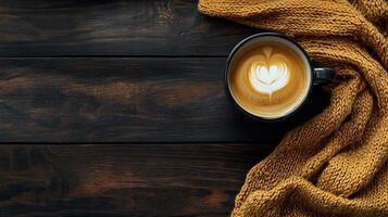 Cozy scene with a coffee cup and a knitted scarf on a rustic table photo