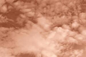 Fluffy curly clouds on sky. Textured Mocha brown background for design. Selective focus. Demonstrating color of 2025 year photo