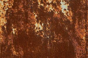 Texture of rusty metal surface with cracked peeling paint. Rusty background photo