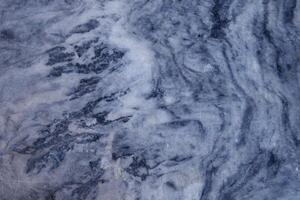 Light gray marble with dark gray curve streak texture and scratched line on surface. photo