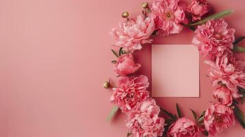 Pink peonies flower wreath on pink background photo