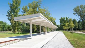 A white covered platform with a bench and trees photo