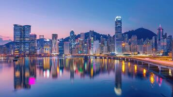 Hong kong skyline at dusk with lights reflecting in water photo