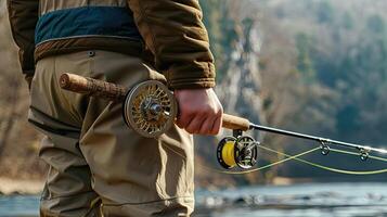 A man holding a fishing rod and reel photo