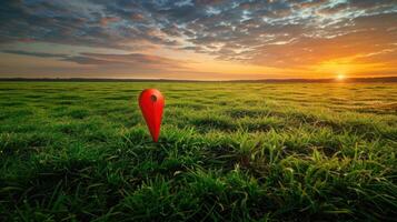 A red arrow in a field of grass at sunset photo