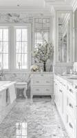 A bathroom with marble flooring and white cabinets photo