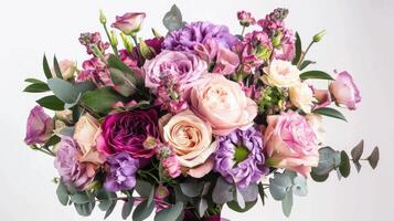 A bouquet of purple and pink flowers in a vase photo