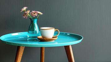 A vase of flowers and a cup of coffee on a table photo