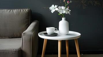 A white vase with a flower on top of a table photo