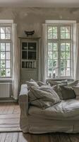A living room with a couch and a window photo
