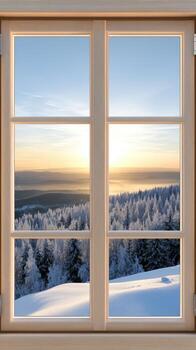 An open window with snow covered trees and a view of the sunrise photo