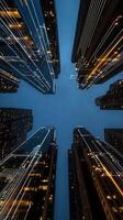A view of tall buildings at night with lights photo