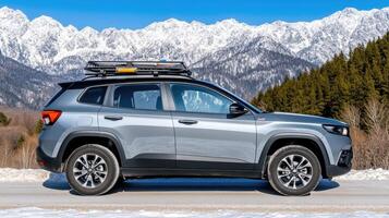 The 2020 jeep compass is parked on the side of the road with snow covered mountains in the photo