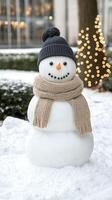 A snowman wearing a hat and scarf photo