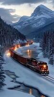 A train traveling through the snow covered mountains photo