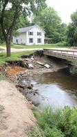 A bridge that is underwater and has a house on the other side photo