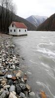 A small house sitting on the edge of a river photo