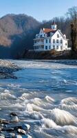 A house sits on the banks of a river photo