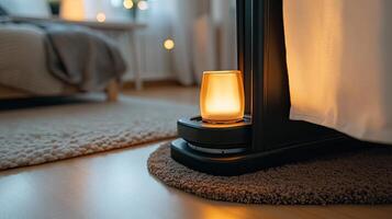 A lamp is sitting on the floor next to a bed photo