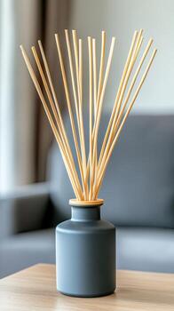 The reed diffuser is placed on the table in front of the couch photo