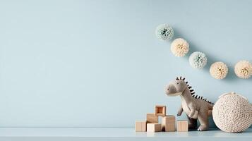 A toy dinosaur and wooden blocks on a blue wall photo