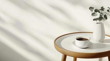 A white vase with a cup of coffee on a table photo