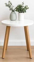 A white table with two potted plants on it photo