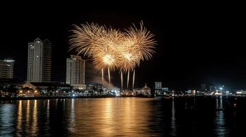 A city skyline with a large firework display over the water photo