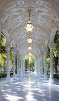 A long walkway with pillars and lights photo