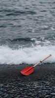 A red paddle on the beach photo