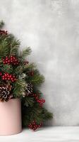 Christmas tree in pink pot with red berries photo