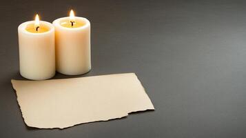 Two burning candles and a piece of paper on a black background photo