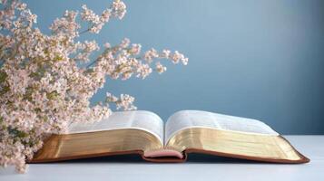 An open bible and flowers on a table photo