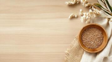 Wheat seeds in wooden bowl on wooden background photo