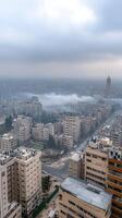 A view of the city from above with buildings and fog photo