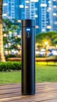 A black portable air purifier sitting on a wooden table photo