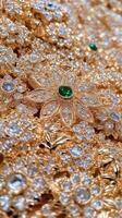 A close up of a gold necklace with emeralds photo