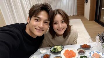 A couple taking a selfie at a table with food photo