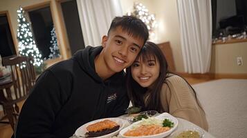 A young couple posing for a photo with food on a table