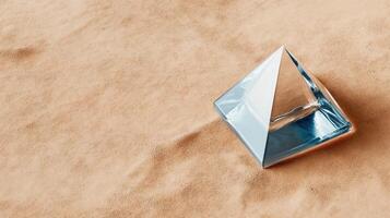 A blue pyramid shaped object on a tan background photo