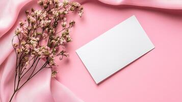 Blank card on pink background with flowers photo