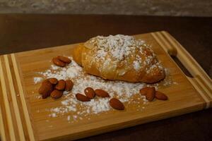 Almond croissant with powdered sugar photo