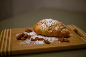 Almond croissant with powdered sugar photo