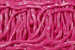 Close-up of vibrant pink, twisted strands resembling candy. photo