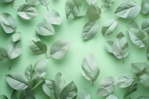 Green leaves scattered on a soft green background. photo